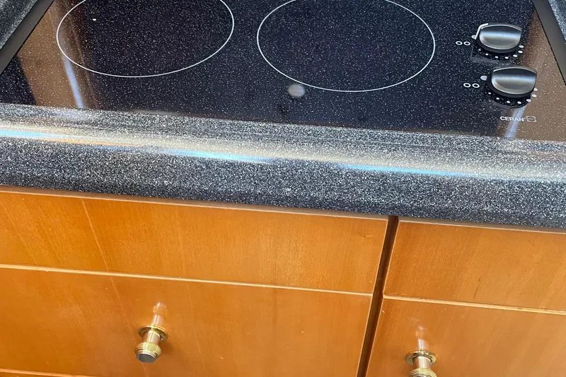  Yacht Photos Pics Ceramic cooktop on 2002 Carver 346 Aft Cabin yacht with wooden cabinetry.