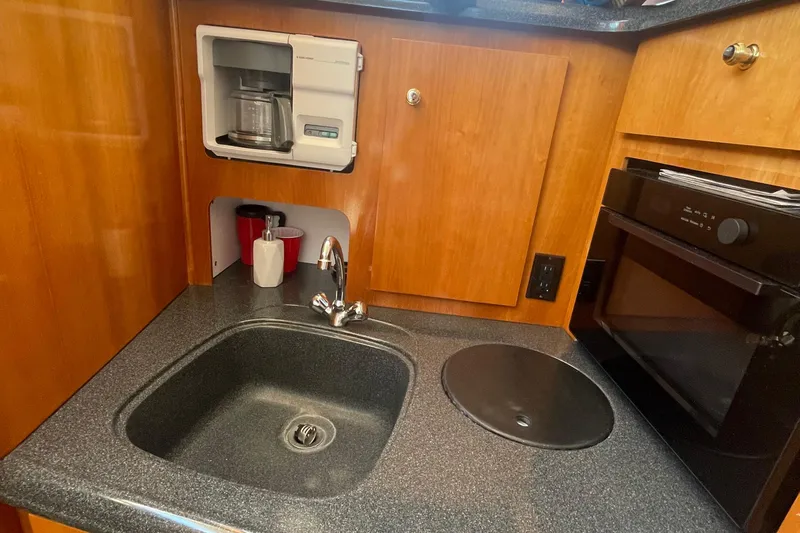  Yacht Photos Pics 2002 Carver 346 Aft Cabin kitchen with sink, coffee maker, and oven.