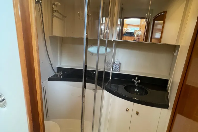  Yacht Photos Pics 2002 Carver 346 Aft Cabin bathroom with shower, black countertop, and mirrored cabinets.