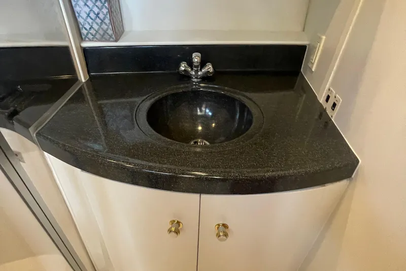  Yacht Photos Pics Black countertop sink in 2002 Carver 346 Aft Cabin yacht bathroom.