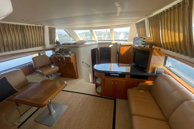 Yacht Photos Pics Luxurious interior of 2002 Carver 346 Aft Cabin yacht with leather seating and helm station.