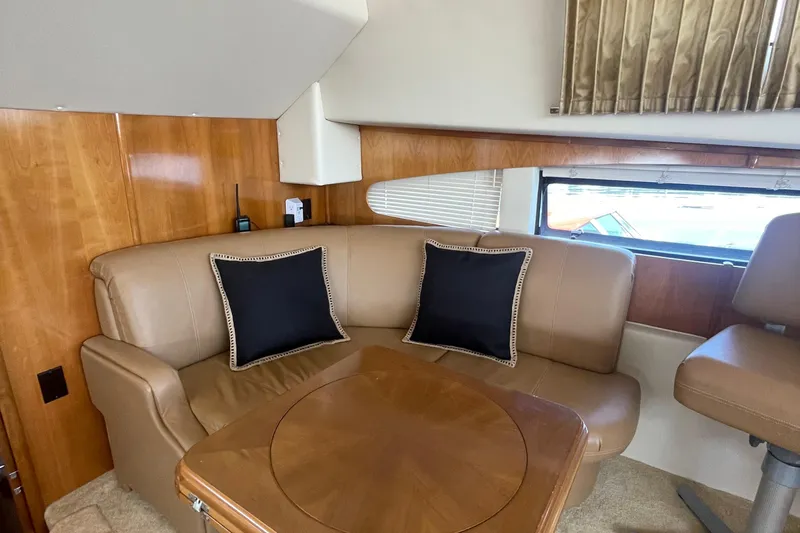  Yacht Photos Pics Luxurious interior of 2002 Carver 346 Aft Cabin with leather seating and wooden table.