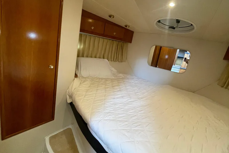  Yacht Photos Pics 2002 Carver 346 Aft Cabin interior with cozy bed and wooden cabinetry.