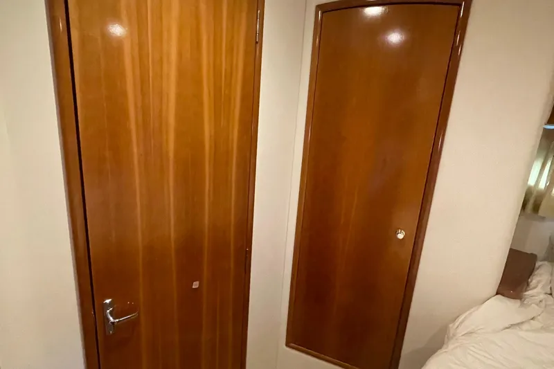  Yacht Photos Pics Interior of 2002 Carver 346 Aft Cabin with wooden doors and cozy bedroom.