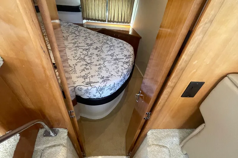  Yacht Photos Pics 2002 Carver 346 Aft Cabin interior with floral bedspread and wooden cabinetry.