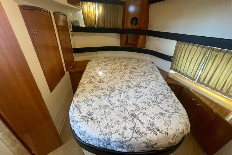  Yacht Photos Pics Cozy bedroom in 2002 Carver 346 Aft Cabin with floral bedding and wooden cabinetry.