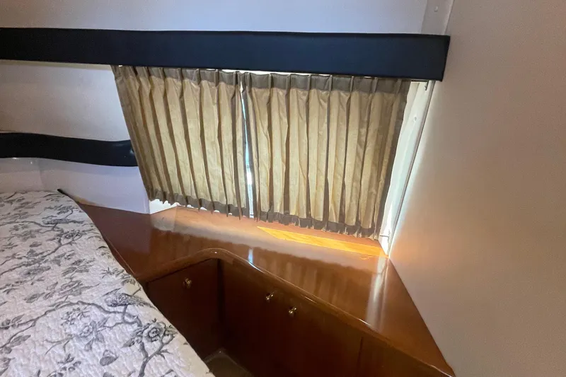  Yacht Photos Pics Interior of 2002 Carver 346 Aft Cabin with wood cabinetry and window curtains.