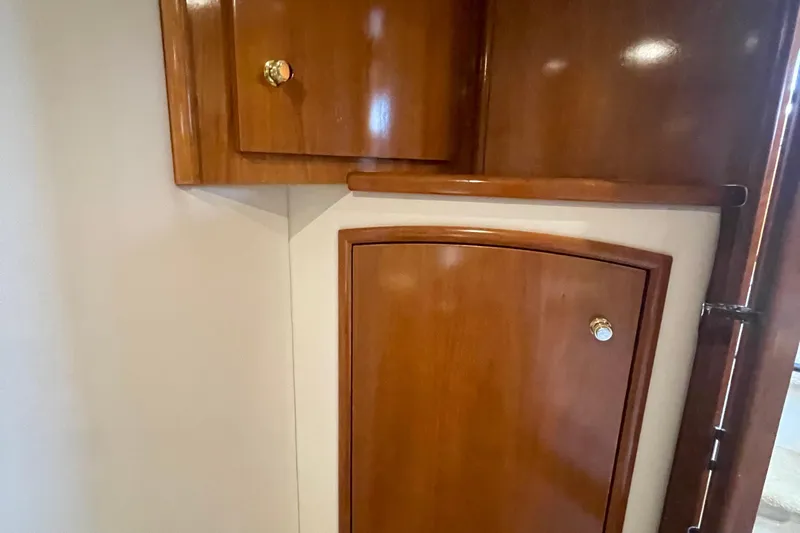  Yacht Photos Pics Wooden cabinetry inside 2002 Carver 346 Aft Cabin yacht, featuring polished doors and brass knobs.