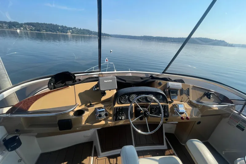  Yacht Photos Pics Helm of 2002 Carver 346 Aft Cabin yacht with scenic lake view.