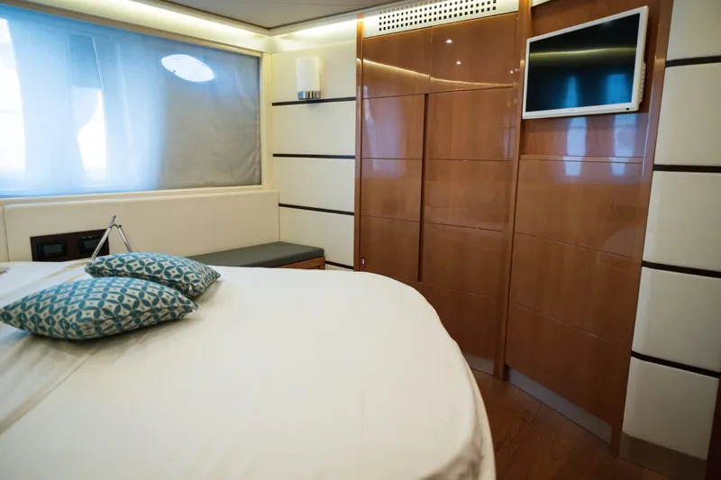  Yacht Photos Pics Luxurious bedroom interior of 2006 Pershing 62' yacht with modern design and TV.