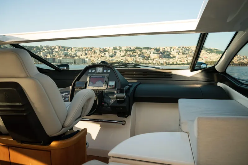  Yacht Photos Pics Interior view of 2006 Pershing 62' yacht cockpit with cityscape in background.