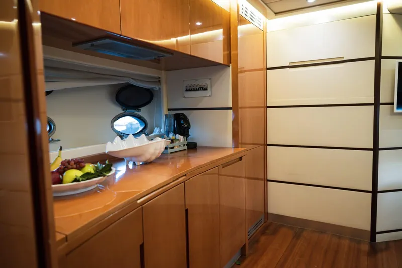  Yacht Photos Pics Luxurious interior of a 2006 Pershing 62' yacht with elegant wood cabinetry.