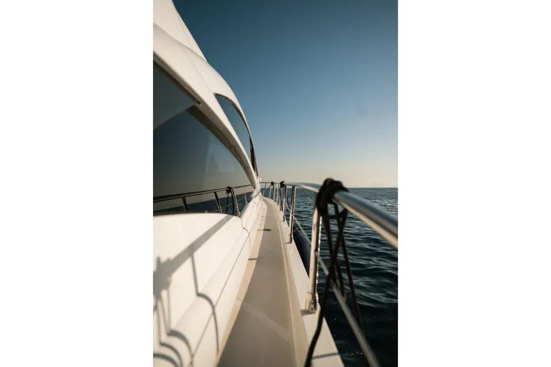  Yacht Photos Pics Side view of a 2006 Pershing 62' yacht cruising on open water.