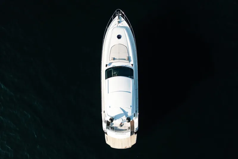  Yacht Photos Pics Aerial view of 2006 Pershing 62' yacht on dark water.