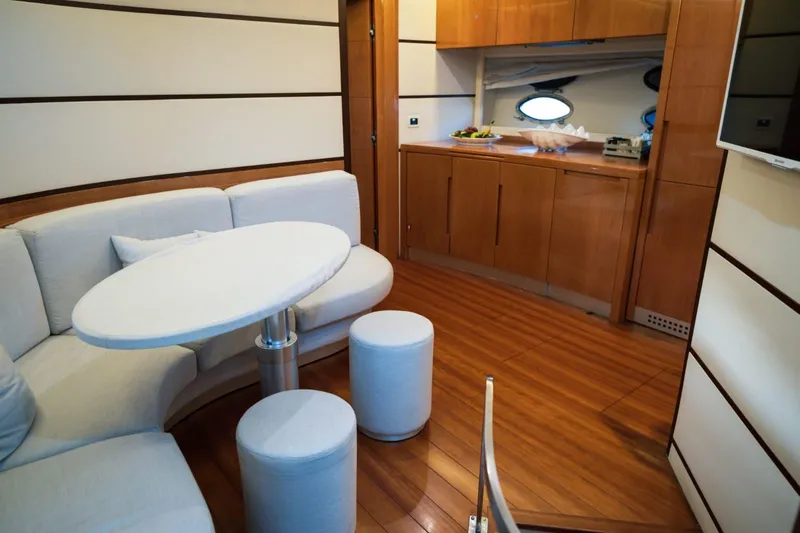  Yacht Photos Pics Luxurious interior of 2006 Pershing 62' yacht with modern seating and wooden cabinetry.