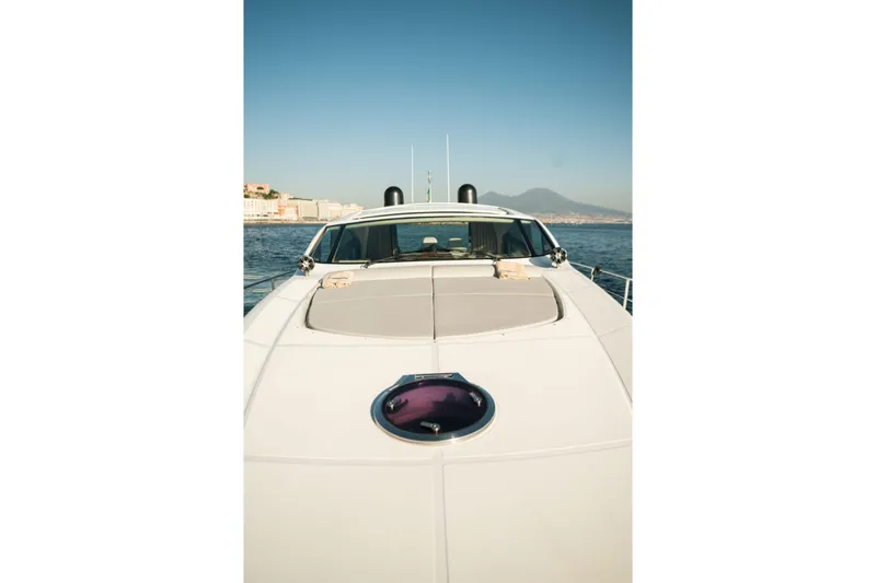  Yacht Photos Pics 2006 Pershing 62' yacht on calm sea with distant mountains.