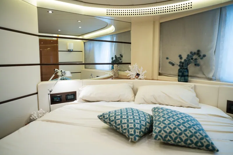  Yacht Photos Pics Luxurious bedroom interior of a 2006 Pershing 62' yacht with elegant decor and soft lighting.