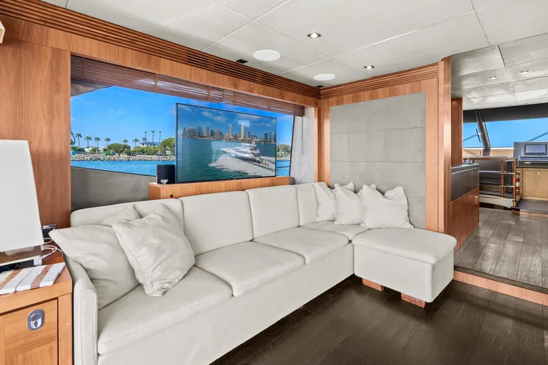  Yacht Photos Pics Luxurious interior of a 2014 Sunseeker 75 Yacht with a white sectional sofa.