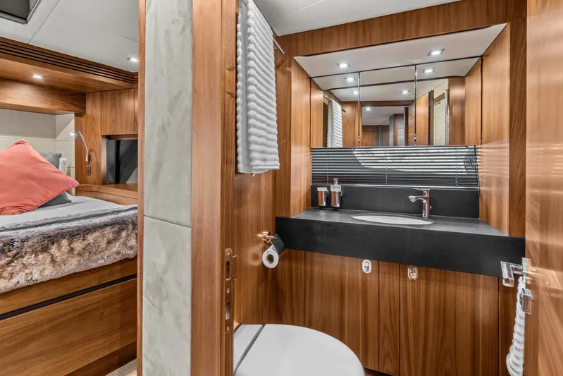  Yacht Photos Pics Luxurious bathroom in 2014 Sunseeker 75 Yacht with modern fixtures and wood accents.