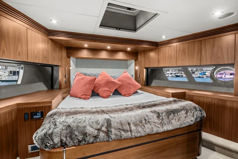  Yacht Photos Pics Luxurious master bedroom in a 2014 Sunseeker 75 Yacht with wood paneling and plush bedding.