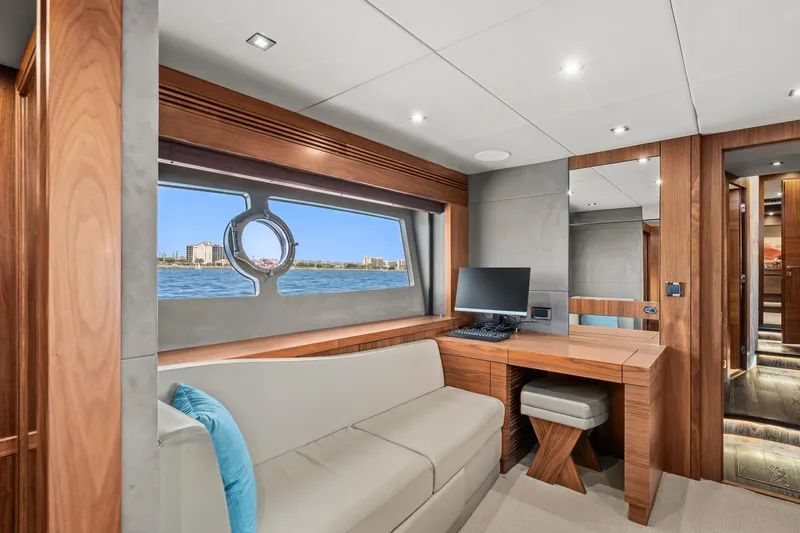  Yacht Photos Pics Luxurious interior of 2014 Sunseeker 75 Yacht with desk, sofa, and ocean view.