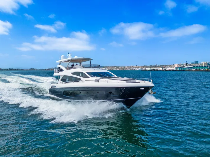  Yacht Photos Pics 2014 Sunseeker 75 Yacht cruising on open water under a clear blue sky.