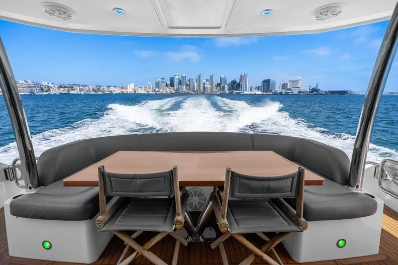  Yacht Photos Pics View from the 2014 Sunseeker 75 Yacht, overlooking city skyline and ocean wake.