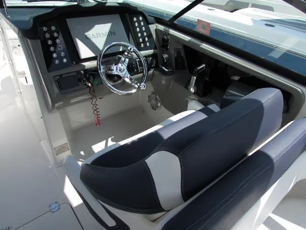 317-147 Ray Brokerage Yacht Photos Pics 2018 Robalo R317 Dual Console boat cockpit with steering wheel and Garmin display.