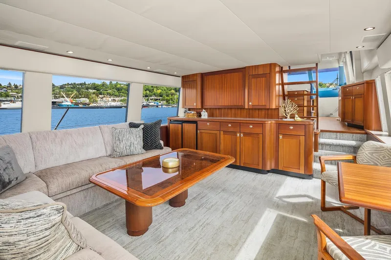 Escencia Yacht Photos Pics Luxurious interior of 2003 Pacific Mariner Pilothouse yacht with elegant wood cabinetry and waterfront view.