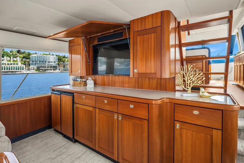 Escencia Yacht Photos Pics Luxurious 2003 Pacific Mariner Pilothouse interior with elegant wood cabinetry and waterfront view.