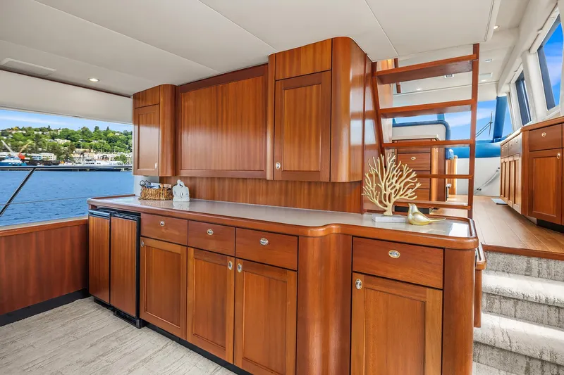 Escencia Yacht Photos Pics Luxurious 2003 Pacific Mariner Pilothouse interior with elegant wood cabinetry and scenic water view.