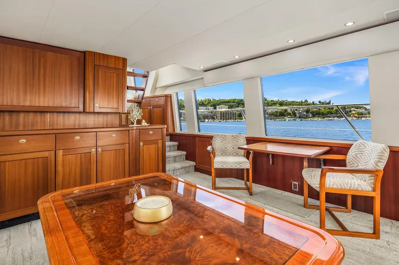 Escencia Yacht Photos Pics Luxurious interior of 2003 Pacific Mariner Pilothouse yacht with elegant wood furnishings and scenic water view.