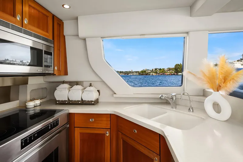 Escencia Yacht Photos Pics Luxurious kitchen interior of 2003 Pacific Mariner Pilothouse yacht with scenic window view.