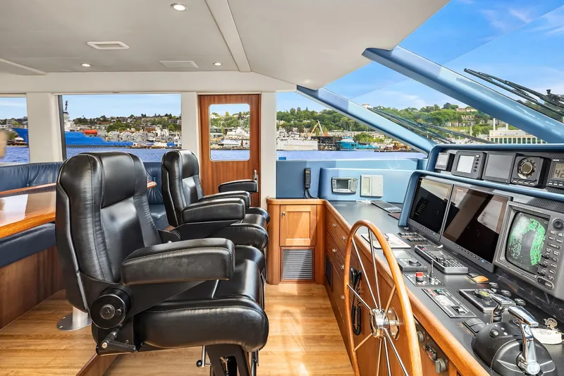 Escencia Yacht Photos Pics 2003 Pacific Mariner Pilothouse interior with leather chairs and advanced navigation equipment.