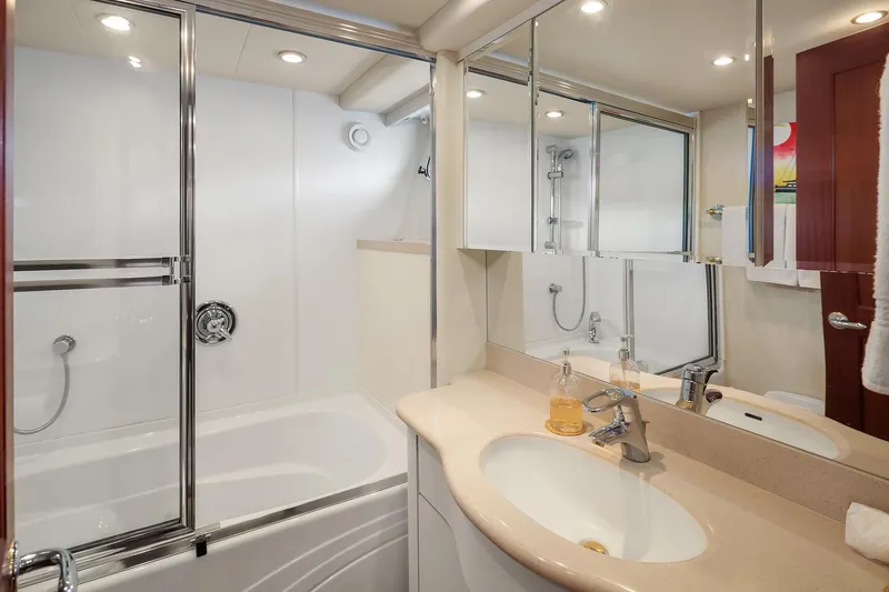 Escencia Yacht Photos Pics Luxurious bathroom in 2003 Pacific Mariner Pilothouse yacht with modern fixtures and mirrored cabinets.