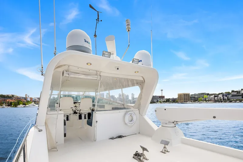 Escencia Yacht Photos Pics 2003 Pacific Mariner Pilothouse yacht on calm water with city skyline in background.