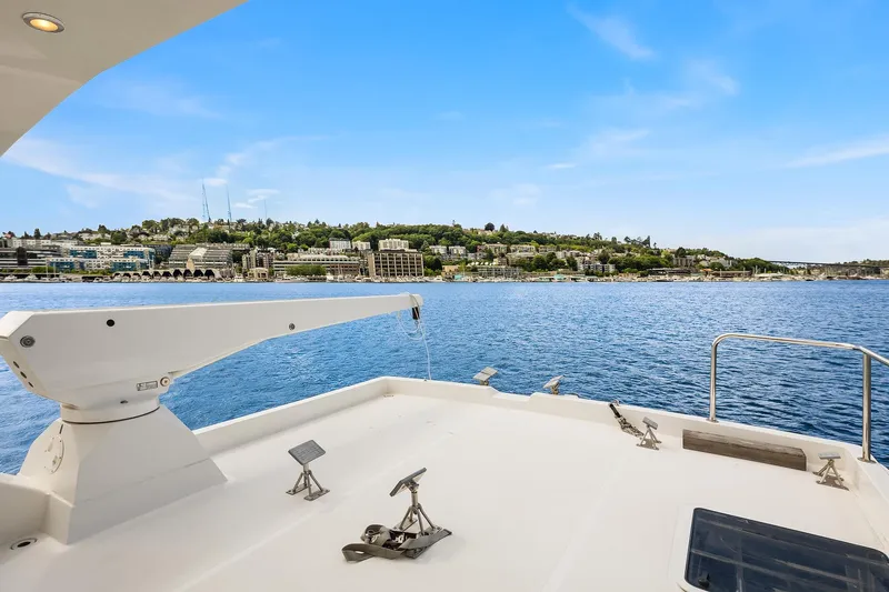 Escencia Yacht Photos Pics 2003 Pacific Mariner Pilothouse yacht deck with scenic waterfront view.