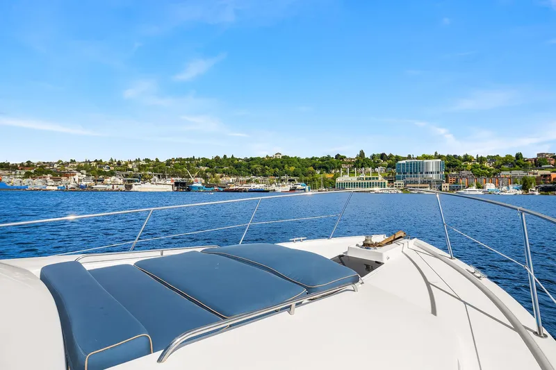 Escencia Yacht Photos Pics 2003 Pacific Mariner Pilothouse yacht cruising on a sunny day with scenic waterfront view.