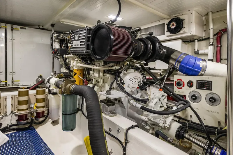 Escencia Yacht Photos Pics Engine room of a 2003 Pacific Mariner Pilothouse yacht, showcasing mechanical components and controls.