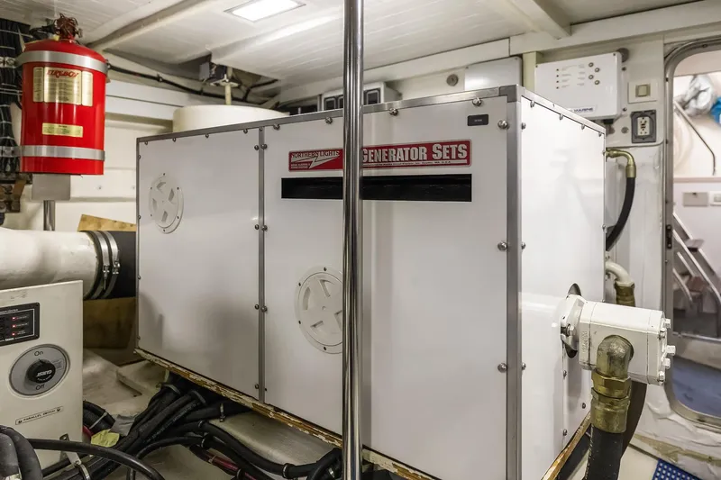 Escencia Yacht Photos Pics Engine room of 2003 Pacific Mariner Pilothouse with generator set and fire extinguisher.