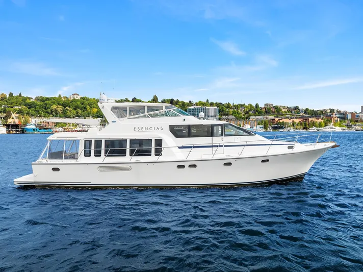 Escencia Yacht Photos Pics 2003 Pacific Mariner Pilothouse yacht on a sunny day, cruising on blue waters.