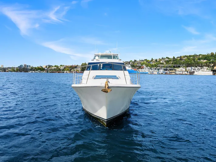 Escencia Yacht Photos Pics 2003 Pacific Mariner Pilothouse yacht on open water, clear blue sky background.