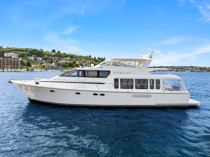 Escencia Yacht Photos Pics 2003 Pacific Mariner Pilothouse yacht on calm blue water under clear sky.