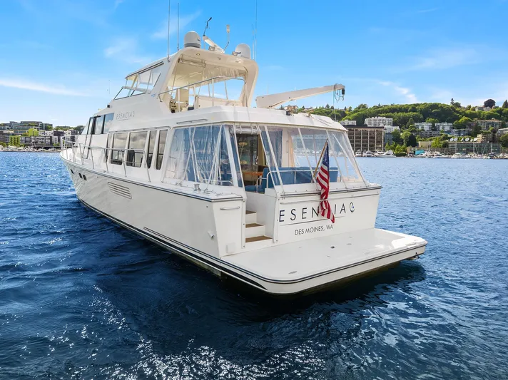Escencia Yacht Photos Pics 2003 Pacific Mariner Pilothouse yacht on water, rear view with American flag.