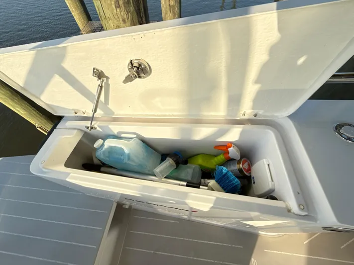 Yacht Photos Pics Open storage compartment on 2019 Axopar 28 CABIN boat with cleaning supplies.