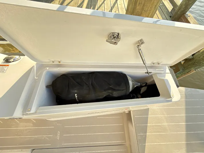  Yacht Photos Pics Open storage compartment on 2019 Axopar 28 CABIN boat with gear inside.