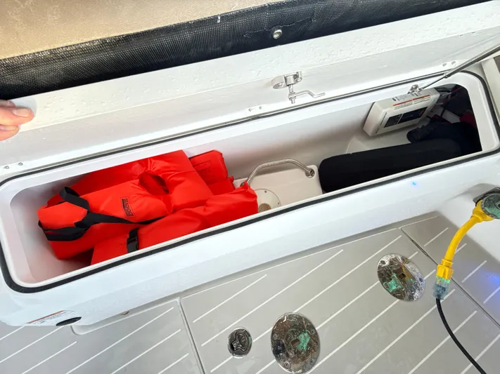  Yacht Photos Pics Storage compartment on 2019 Axopar 28 CABIN with life jackets and equipment.