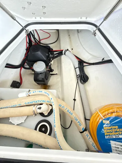  Yacht Photos Pics 2019 Axopar 28 CABIN storage compartment with cables and marine equipment.