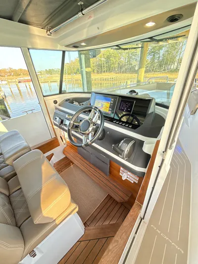  Yacht Photos Pics 2019 Axopar 28 CABIN interior with modern dashboard and steering wheel.