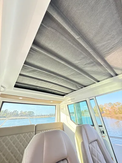  Yacht Photos Pics 2019 Axopar 28 CABIN interior with sunroof and water view.